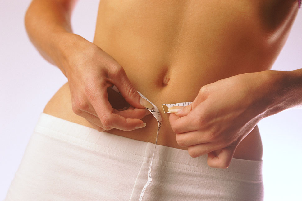 woman measuring waist